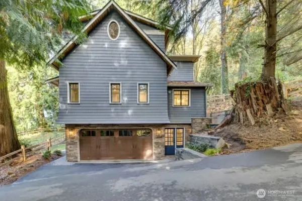 a view of a house with a small yard and wooden fence