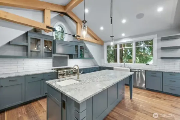 a kitchen with granite countertop a sink and window