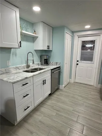 a kitchen with a sink a stove and cabinets