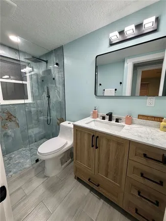 a bathroom with a double vanity sink mirror and toilet