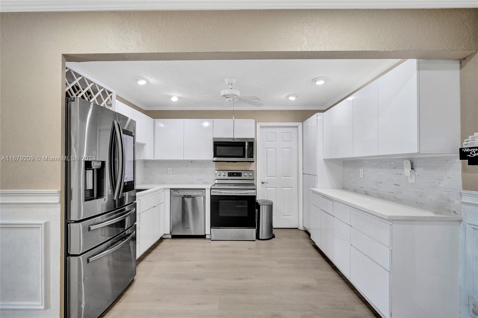 9737 Alaska Circle Boca Raton, FL 33434 - Photo 17 of 37 a kitchen with stainless steel appliances granite countertop a refrigerator and a stove