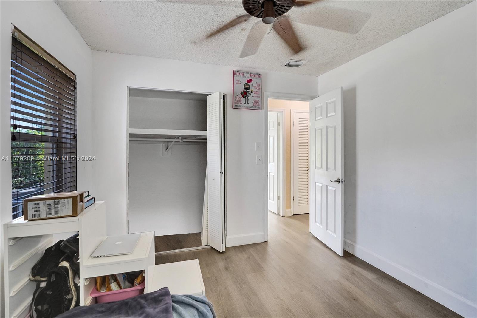 9737 Alaska Circle Boca Raton, FL 33434 - Photo 19 of 37 a view of walk in closet with clothes and shoes