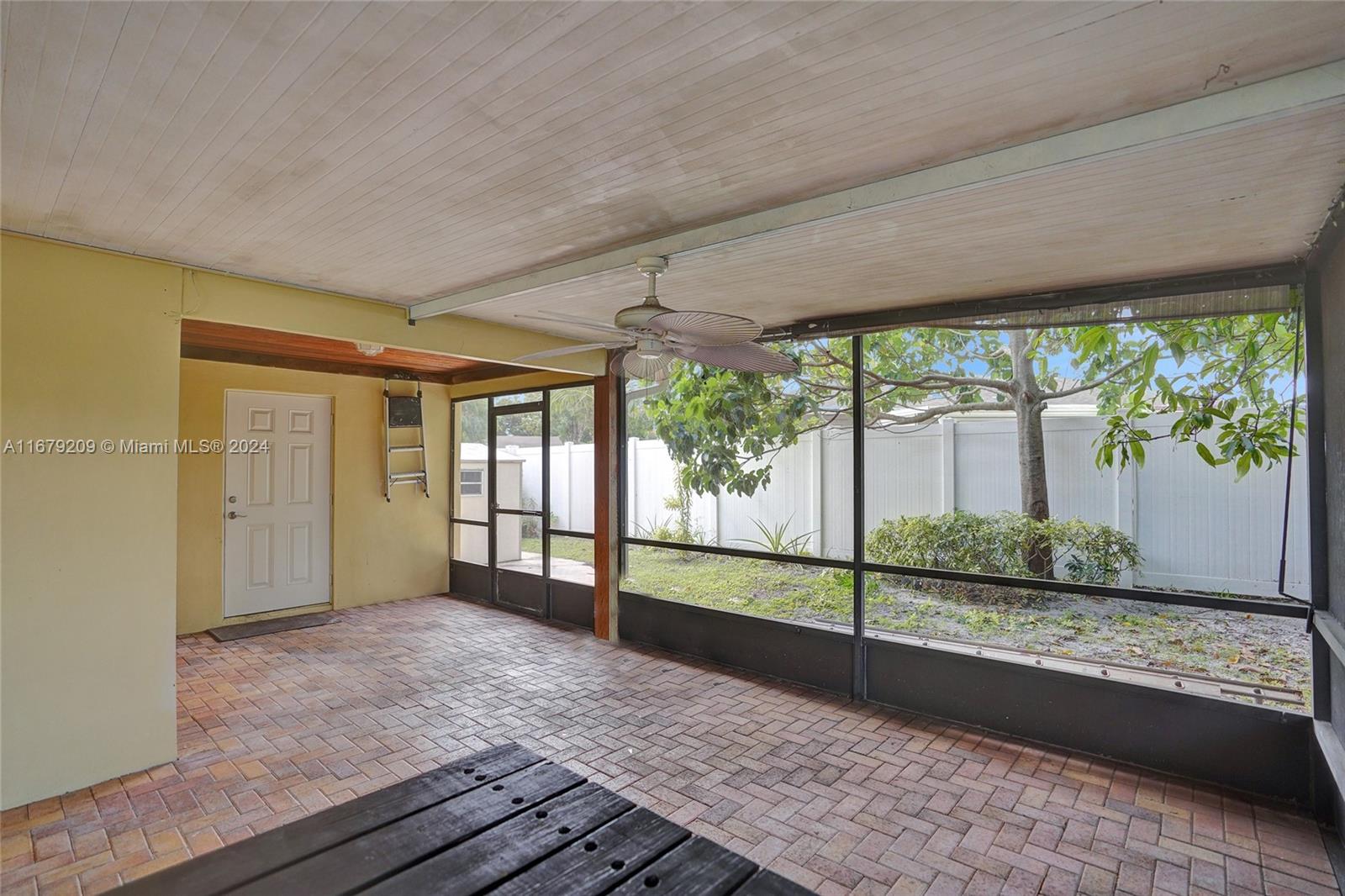 9737 Alaska Circle Boca Raton, FL 33434 - Photo 27 of 37 a view of empty room with wooden floor and floor to ceiling window