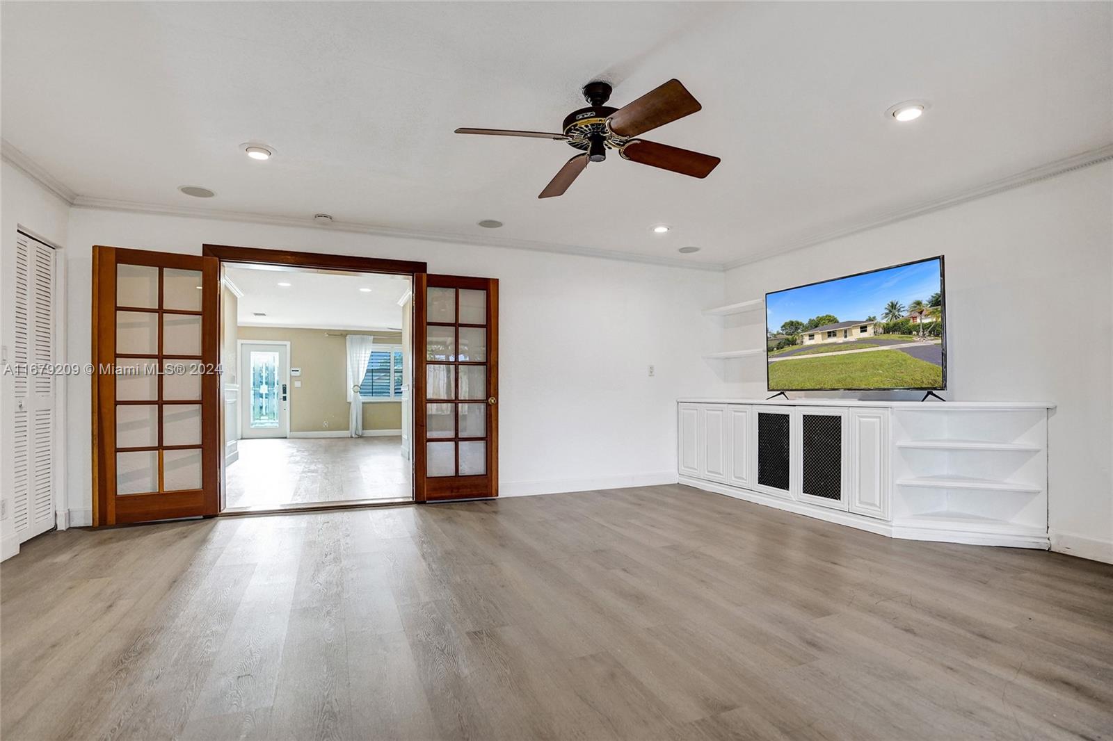 9737 Alaska Circle Boca Raton, FL 33434 - Photo 30 of 37 an empty room with wooden floor cabinet and windows
