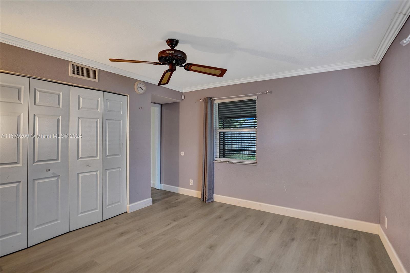 9737 Alaska Circle Boca Raton, FL 33434 - Photo 31 of 37 a view of empty room with wooden floor and fan