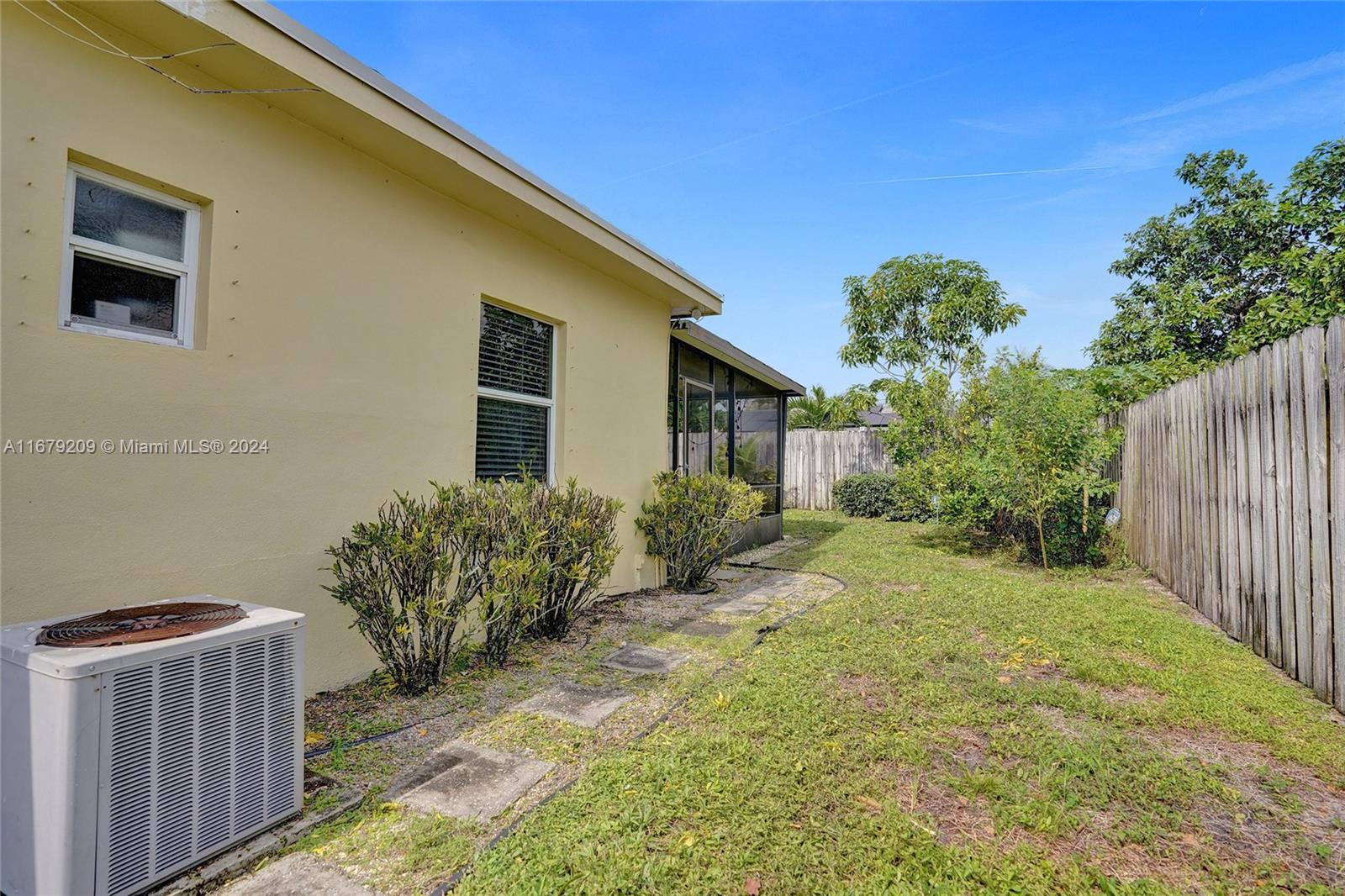 9737 Alaska Circle Boca Raton, FL 33434 - Photo 32 of 37 a front view of a house with garden