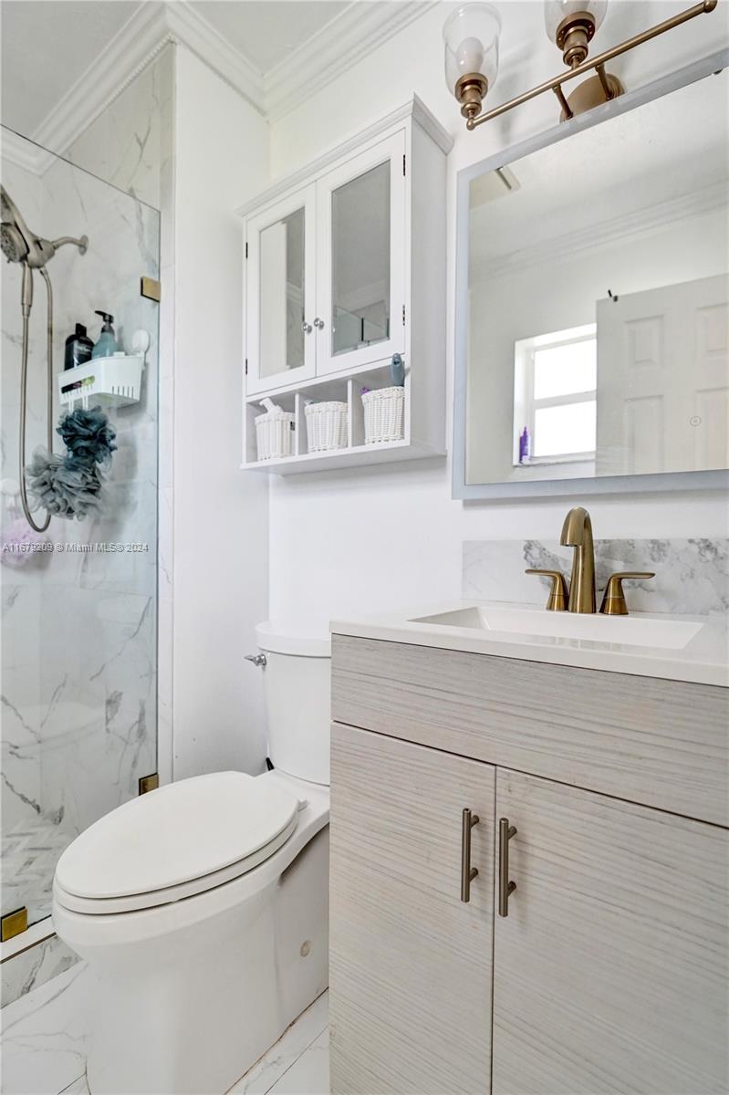 9737 Alaska Circle Boca Raton, FL 33434 - Photo 6 of 37 a bathroom with a sink a toilet and shower