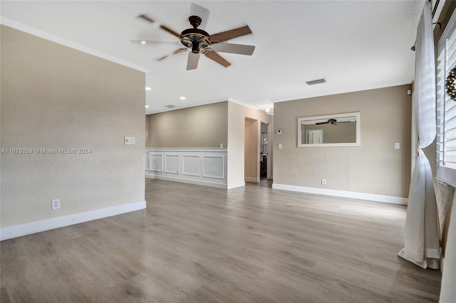 9737 Alaska Circle Boca Raton, FL 33434 - Photo 10 of 37 a view of a livingroom with a ceiling fan wooden floor and a ceiling fan
