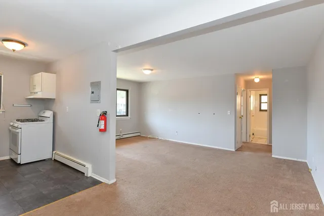 an empty room with windows and closet