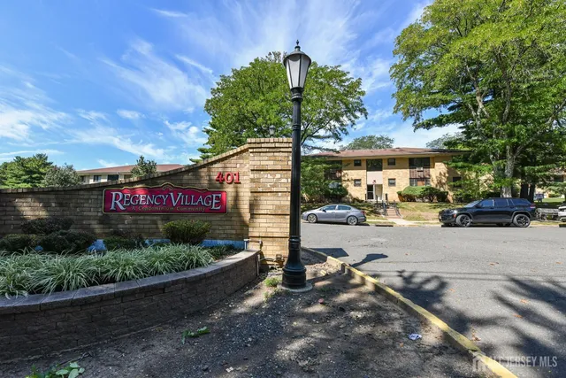 a street sign on a sidewalk next to a road