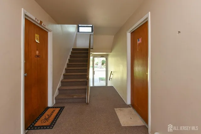 a view of a hallway with entryway a hall with wooden floor