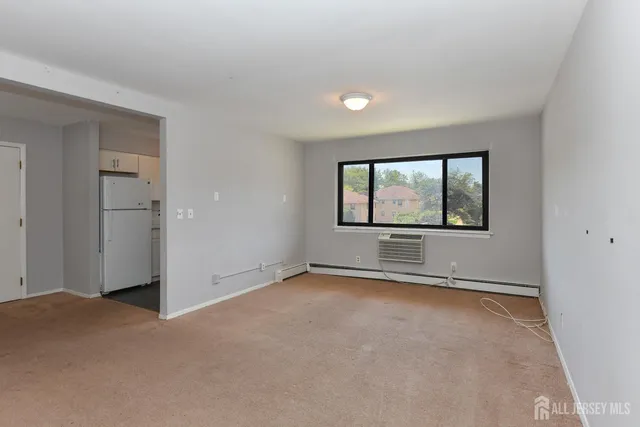 an empty room with a empty space and windows