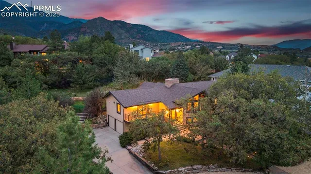an aerial view of a house with a yard