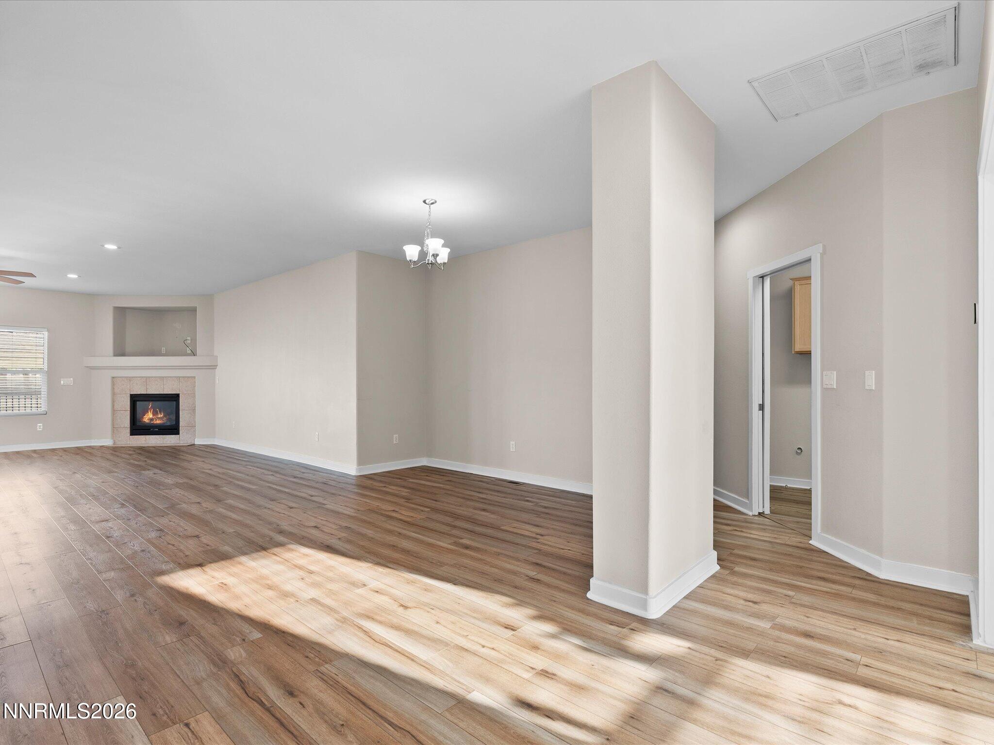 5570 Knoll View Way Sparks, NV 89436 - Photo 14 of 69 an empty room with wooden floor and fireplace