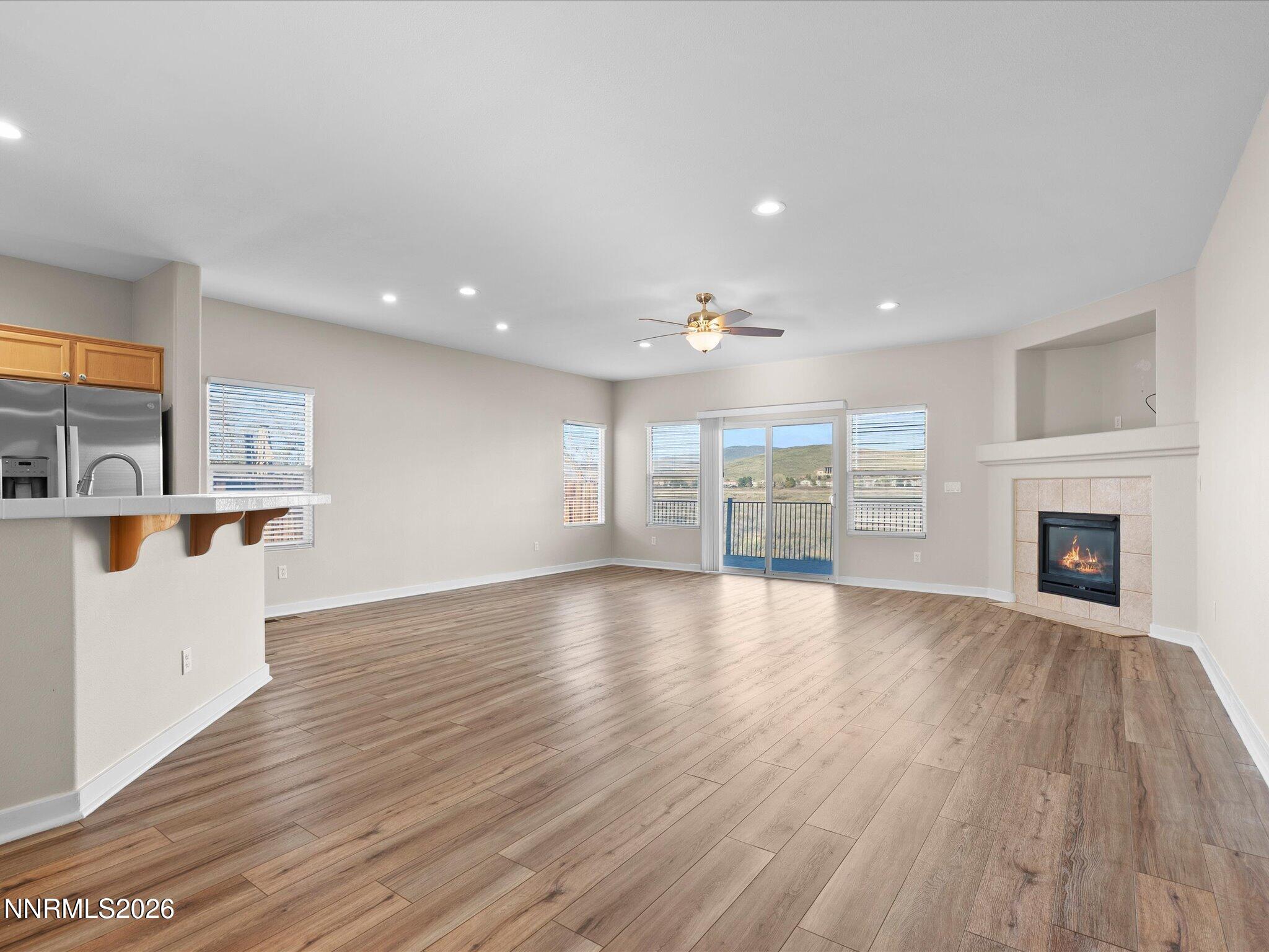 5570 Knoll View Way Sparks, NV 89436 - Photo 18 of 69 a view of an empty room with wooden floor and a fireplace