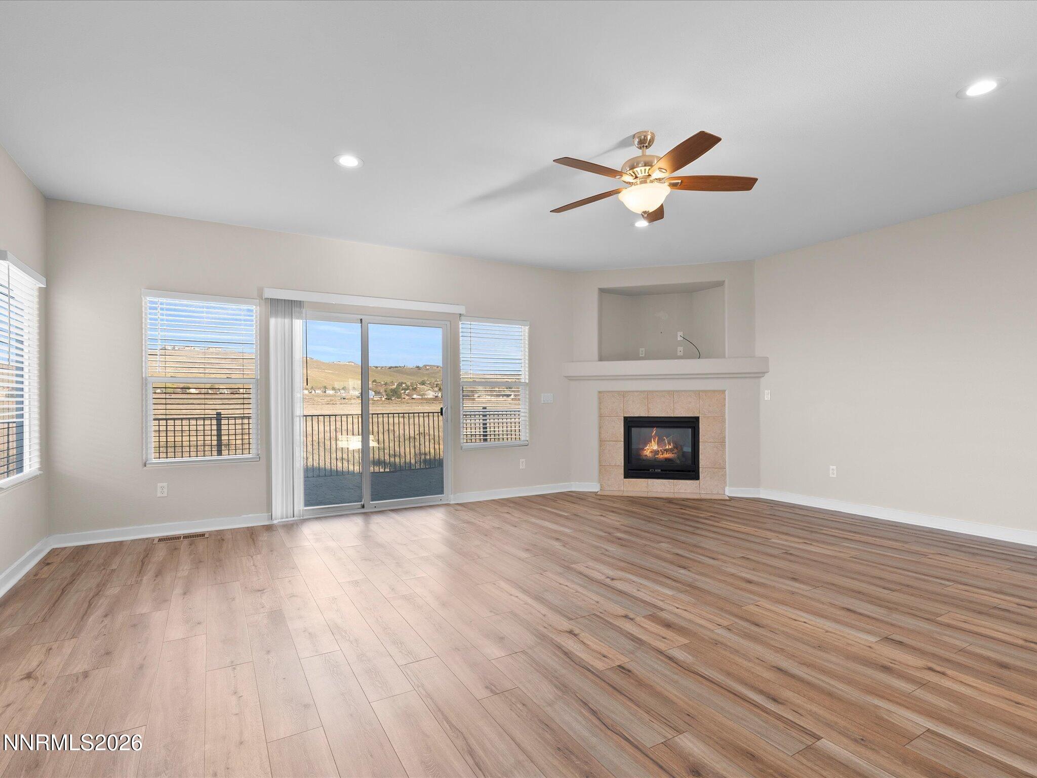 5570 Knoll View Way Sparks, NV 89436 - Photo 19 of 69 a view of a livingroom with a fireplace a ceiling fan and wooden floor