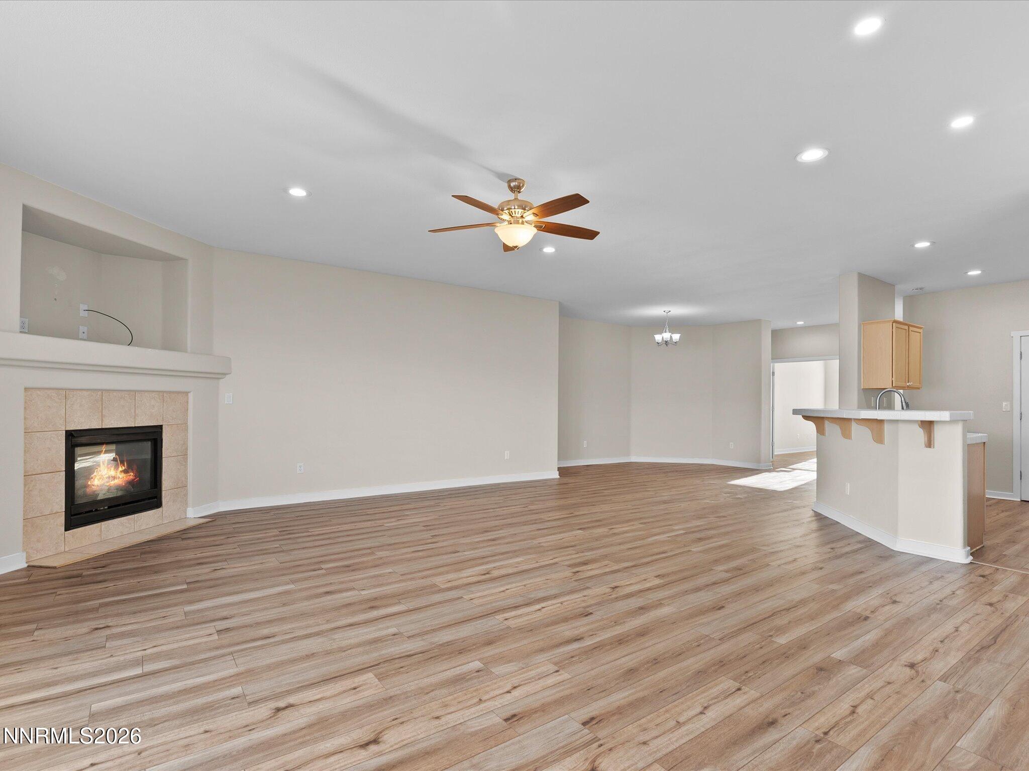 5570 Knoll View Way Sparks, NV 89436 - Photo 22 of 69 a view of an empty room with wooden floor and a fireplace