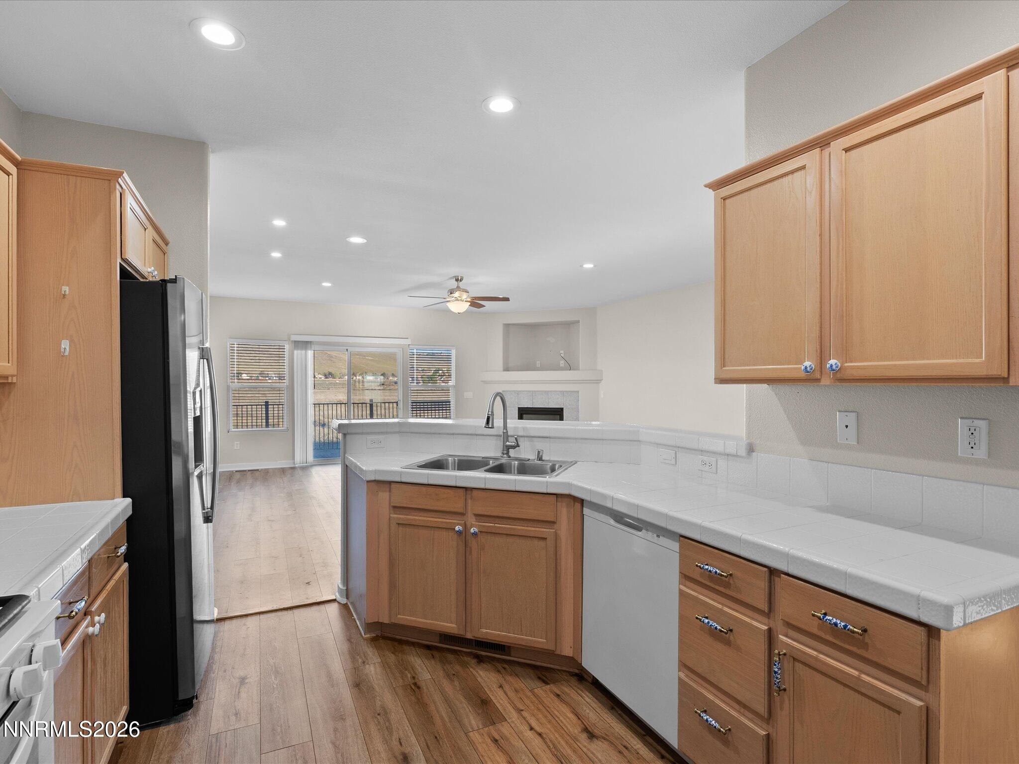 5570 Knoll View Way Sparks, NV 89436 - Photo 26 of 69 a kitchen with a sink stove cabinets and refrigerator