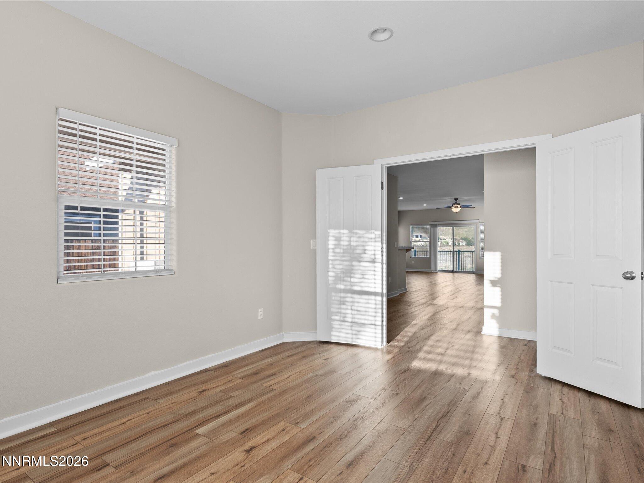 5570 Knoll View Way Sparks, NV 89436 - Photo 29 of 69 a view of an empty room with wooden floor and a window