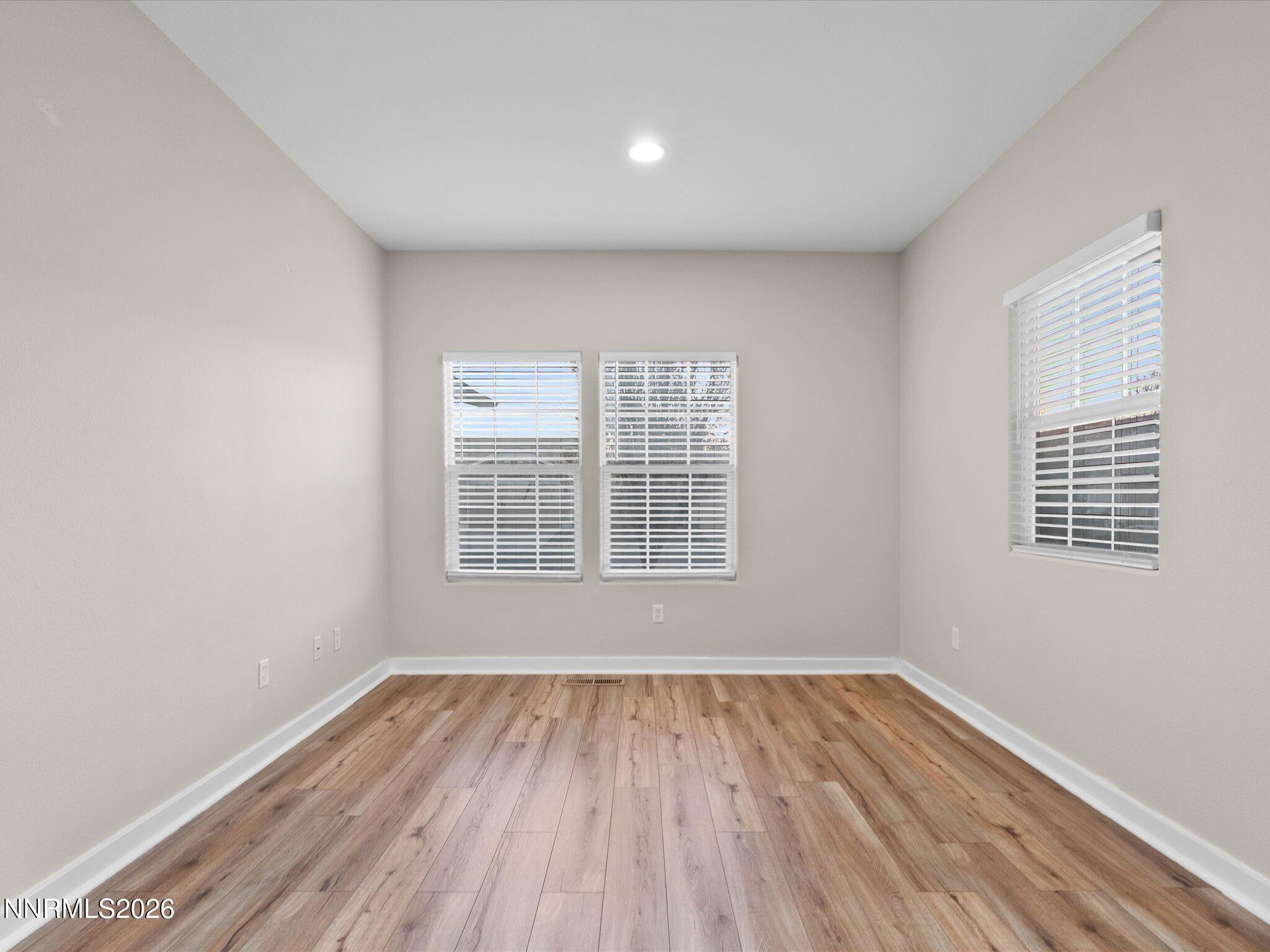 5570 Knoll View Way Sparks, NV 89436 - Photo 30 of 69 a view of an empty room with wooden floor and a window