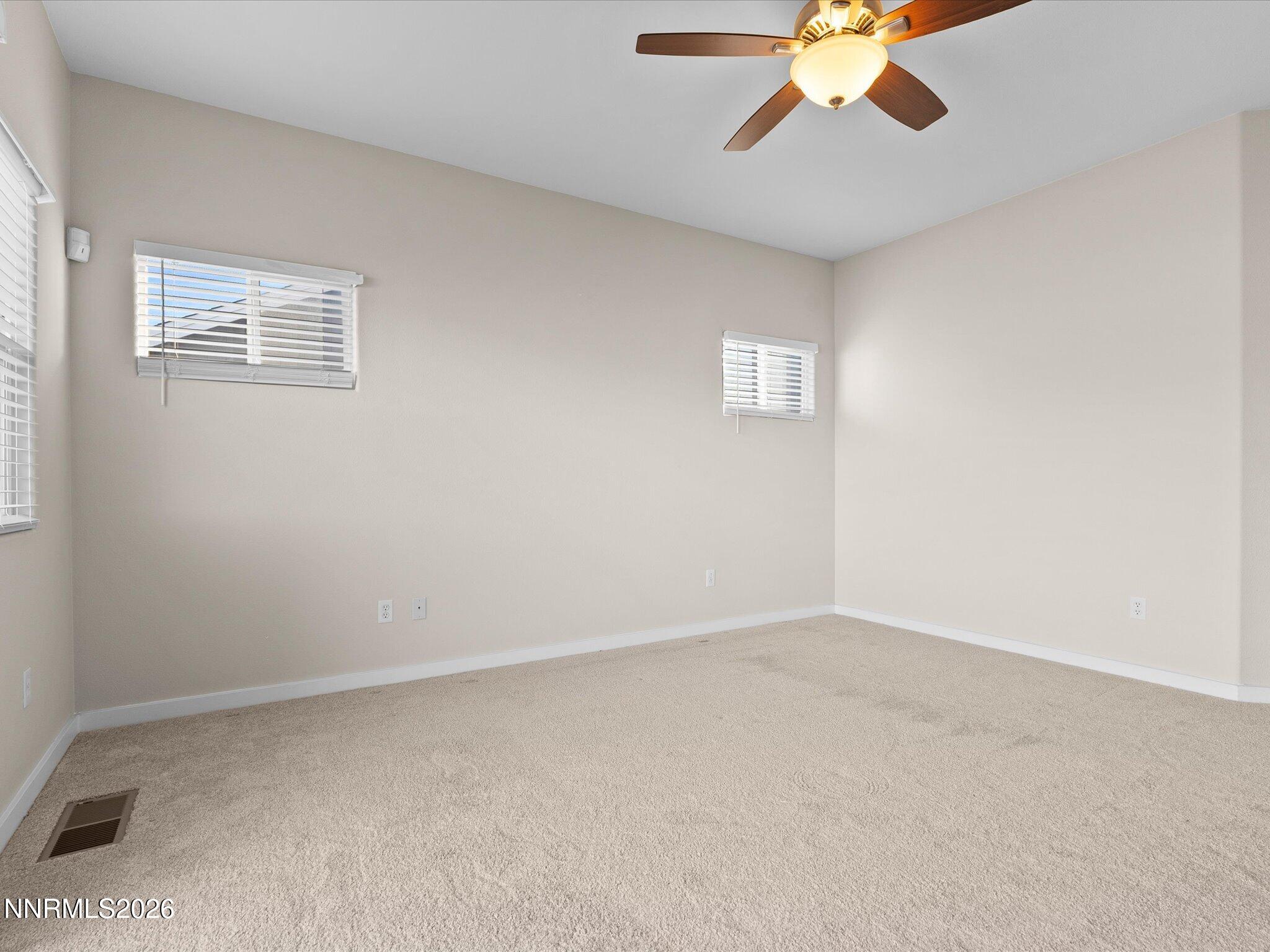5570 Knoll View Way Sparks, NV 89436 - Photo 38 of 69 an empty room with a chandelier fan
