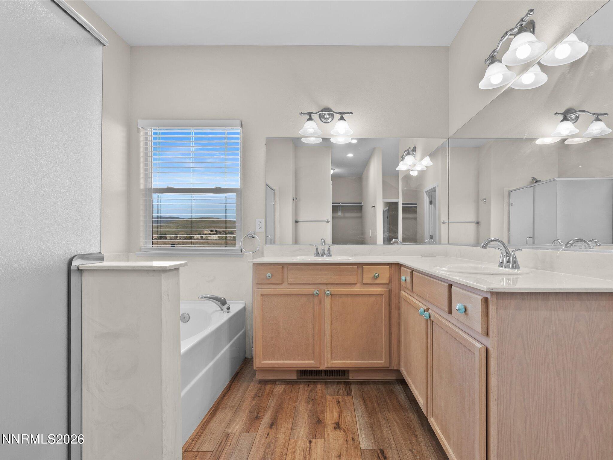 5570 Knoll View Way Sparks, NV 89436 - Photo 40 of 69 a spacious bathroom with a granite countertop sink a mirror and a bathtub