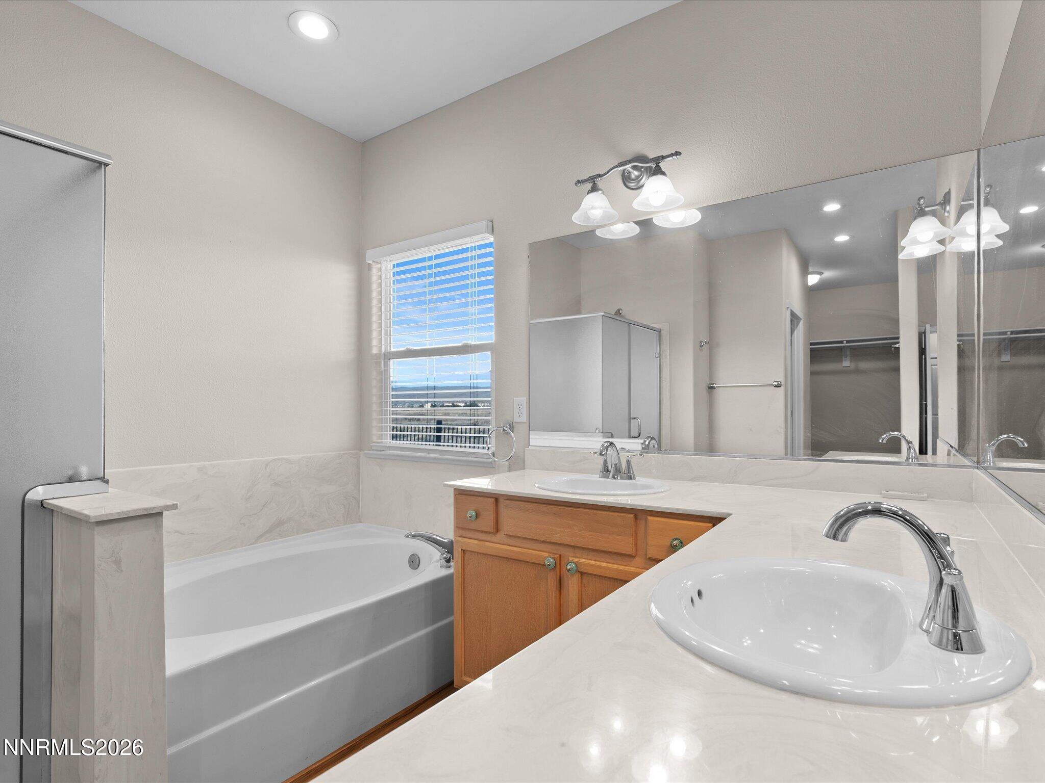 5570 Knoll View Way Sparks, NV 89436 - Photo 41 of 69 a bathroom with a tub sink double vanity and a mirror