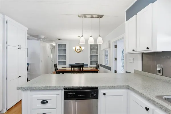 a kitchen with a sink stove and microwave