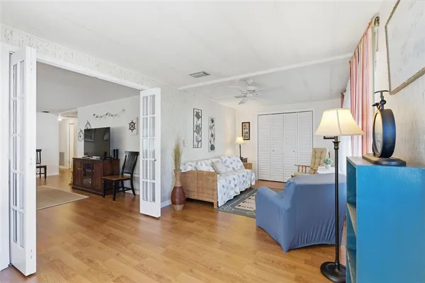 a living room with furniture and wooden floor