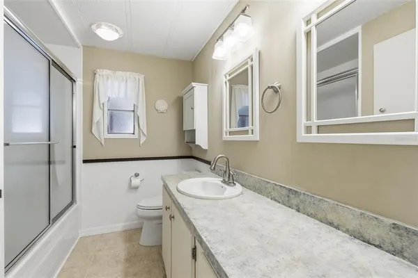 a bedroom with a bed and a night stand