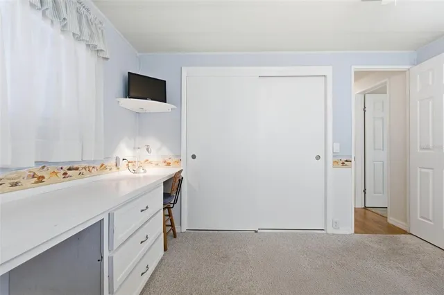 a bedroom with a bed a chandelier and a mirror