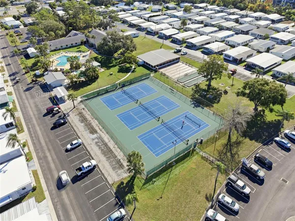 an aerial view of residential houses with yard