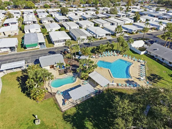 an aerial view of a residential houses with outdoor space