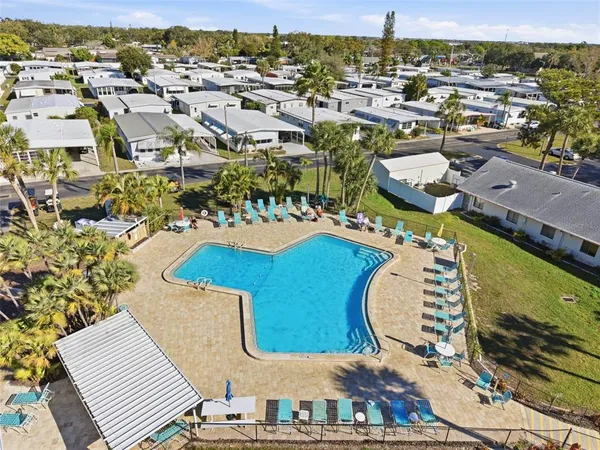 a balcony with dining table and chairs