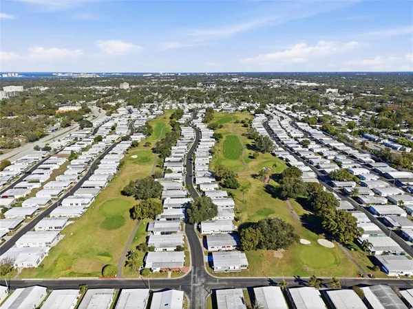 a kitchen with refrigerator and chairs