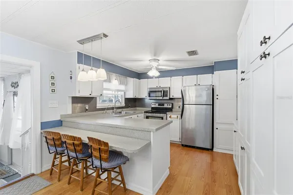a kitchen with stainless steel appliances a refrigerator and a stove