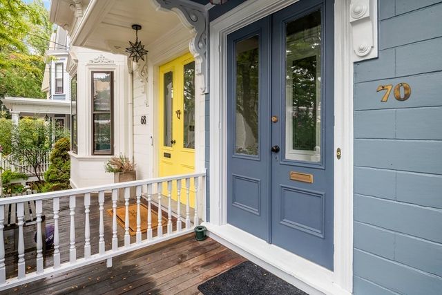 a view of a dining room with furniture a chandelier and wooden floor