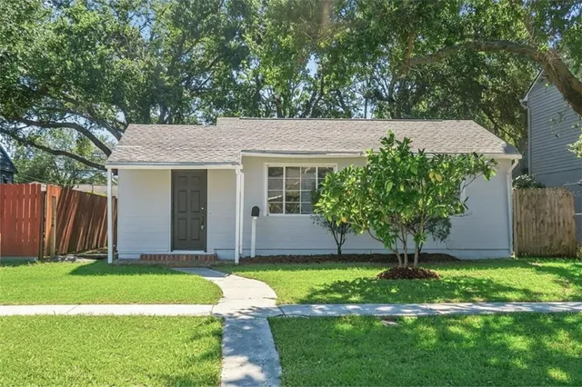a view of a house with yard and a tree