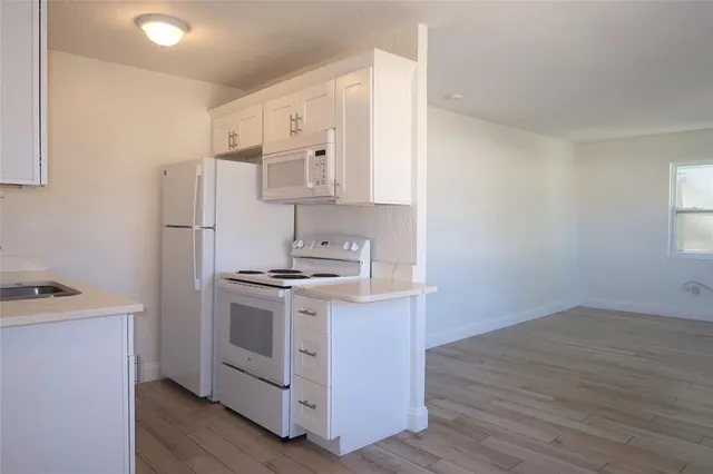 a kitchen with a stove and a refrigerator