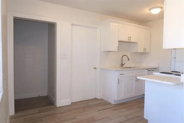 a kitchen with stainless steel appliances granite countertop a sink a stove a refrigerator and cabinets