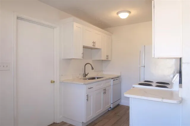 a kitchen with a sink a stove and cabinets