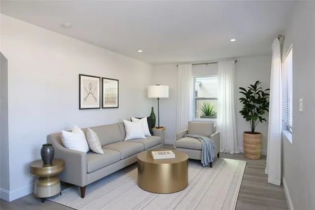 a living room with furniture and a potted plant