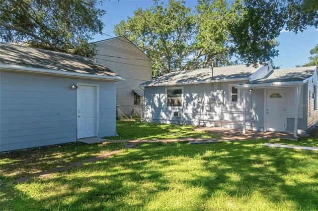 a view of a back yard of the house and front view of a house