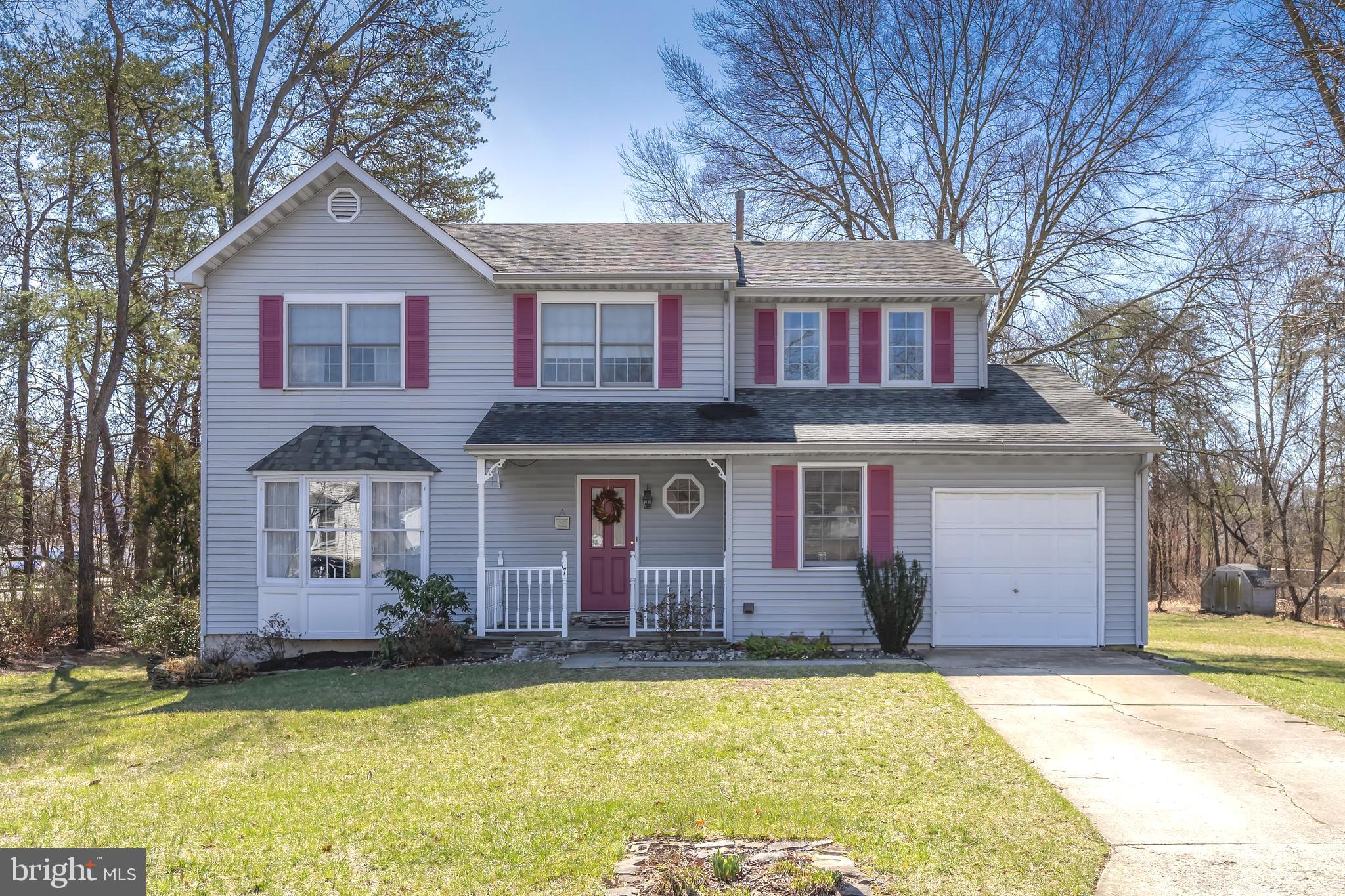 17 Framingham Road Beverly, NJ 08010 - Photo 1 of 24 a front view of a house with a garden and trees