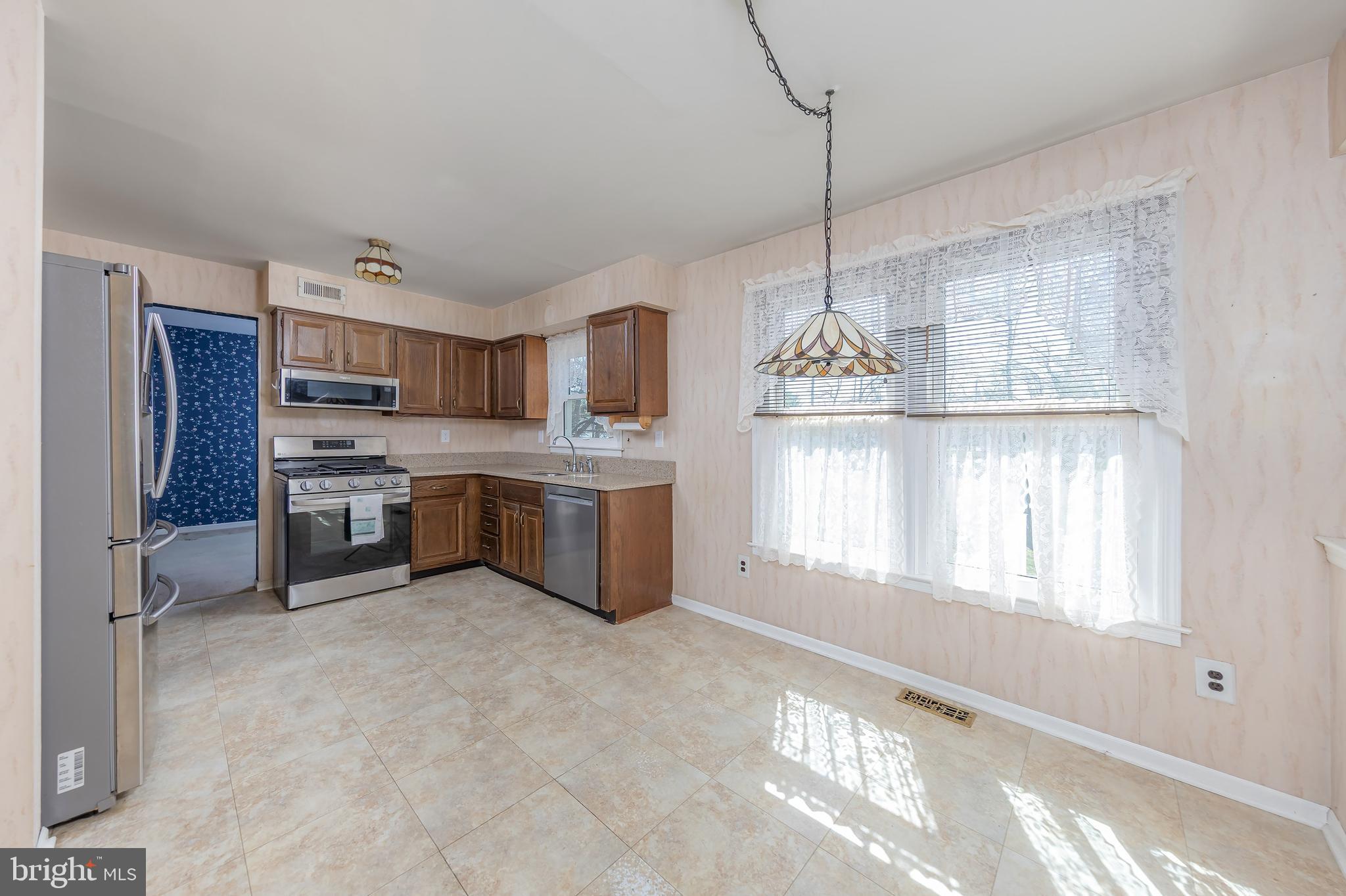 17 Framingham Road Beverly, NJ 08010 - Photo 4 of 24 a kitchen with stainless steel appliances granite countertop a stove and white cabinets