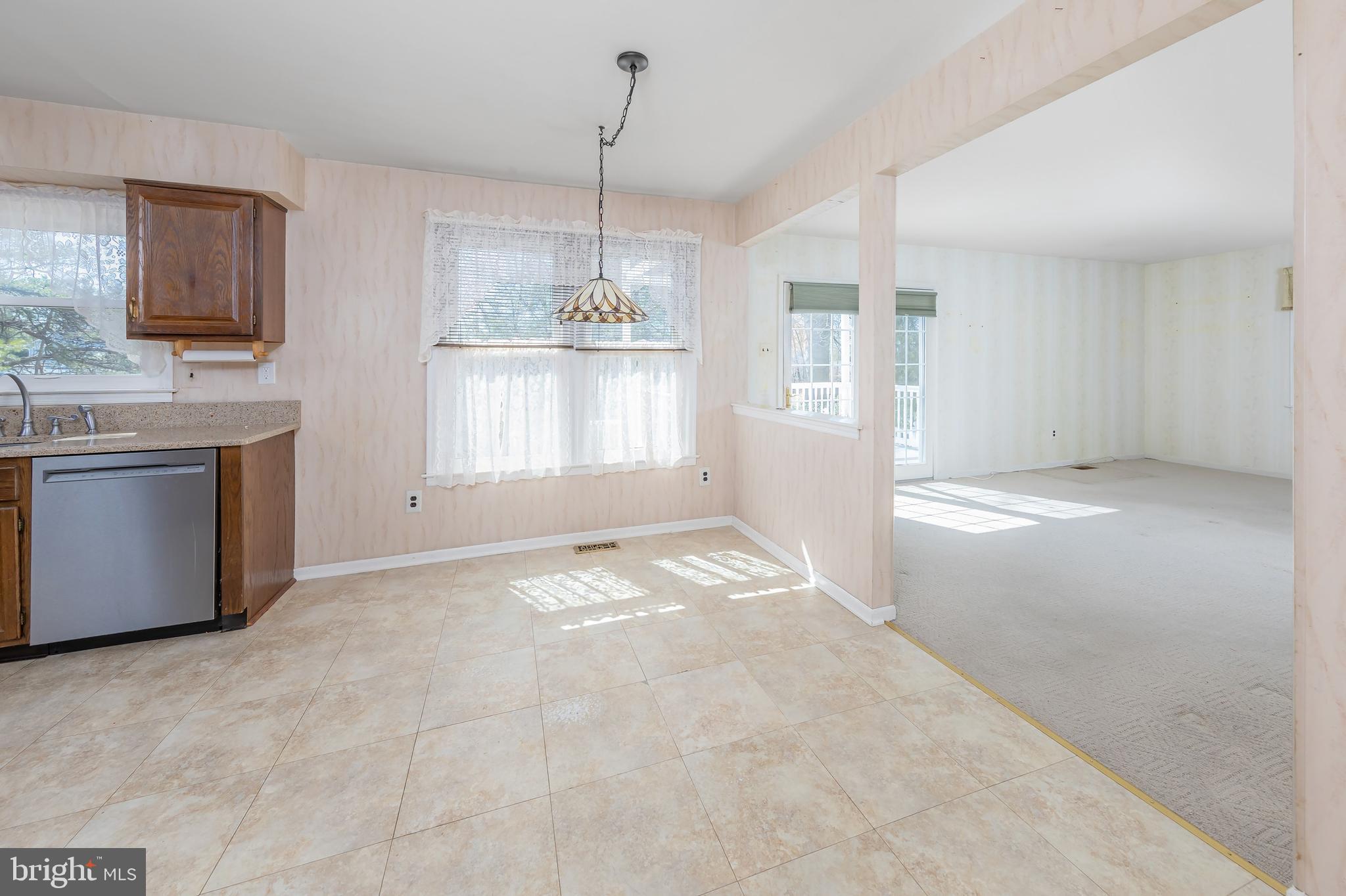 17 Framingham Road Beverly, NJ 08010 - Photo 5 of 24 a view of a kitchen with a sink and dishwasher cabinet