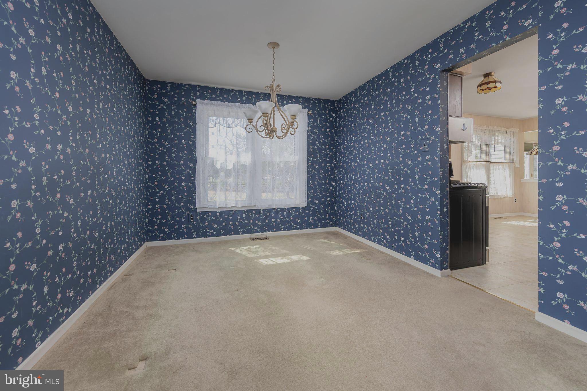 17 Framingham Road Beverly, NJ 08010 - Photo 8 of 24 en empty room with windows and chandelier