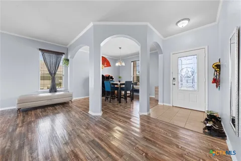 a view of a livingroom with furniture hardwood floor and a ceiling fan
