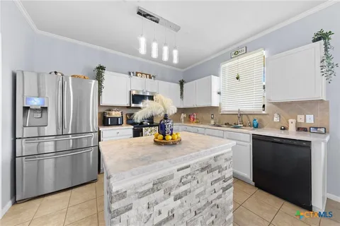 a kitchen with stainless steel appliances granite countertop a refrigerator stove a sink and dishwasher