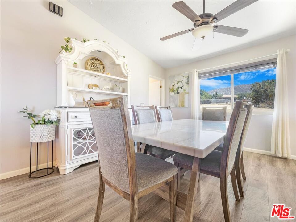 9446 Green Road Pinon Hills, CA 92372 - Photo 2 of 24 a view of a dining room with furniture window and wooden floor